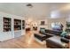 Open living room with built-in shelving and hardwood floors at 7082 Mira Vista St, Las Vegas, NV 89120