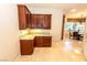 Kitchen wet bar with granite countertop and wood cabinets at 2257 Candlestick Ave, Las Vegas, NV 89052