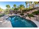 Inviting pool with waterfall feature and surrounding landscaping at 2257 Candlestick Ave, Las Vegas, NV 89052