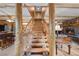 Rustic wooden staircase leading to the upper level of a log cabin home at 4785 Knotty Pine Way, Mount Charleston, NV 89124