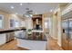 Gourmet kitchen with large island and stone accent wall at 2352 Martinique Ave, Henderson, NV 89044