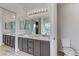 Double vanity bathroom with modern light fixture and a toilet at 10401 Daisy Dawn Ct, Las Vegas, NV 89129