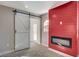 Gathering room with a red accent wall, fireplace, and barn door at 8753 Sundial Dr, Las Vegas, NV 89134