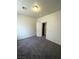 Simple bedroom with grey carpet and door to bathroom at 5738 Bear Springs St, North Las Vegas, NV 89031