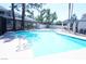 Community pool with surrounding lounge chairs at 5579 Orchard Ln # 5579, Las Vegas, NV 89110