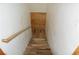 Stairs leading to lower level with wooden handrail at 1382 N Trout Canyon Rd, Las Vegas, NV 89124