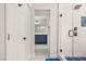 Modern bathroom with walk-in shower, blue vanity, and hexagon tile floor at 3784 Pama Ln, Las Vegas, NV 89120