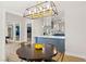 Dining area with round table and modern chandelier at 3784 Pama Ln, Las Vegas, NV 89120