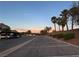 Parking area with palm trees and a sunset backdrop at 1881 W Alexander Rd # 2055, North Las Vegas, NV 89032