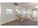 Upstairs hallway with neutral carpet and wooden railing at 8888 Catfish Stream Ave, Las Vegas, NV 89178