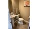 Modern powder room with pedestal sink and updated flooring at 5301 Fairbranch Ln, Las Vegas, NV 89135