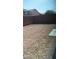 Small backyard with gravel and a concrete slab at 5116 Blue Rose St, North Las Vegas, NV 89081