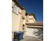 Tan two-story house with a white garage door at 1432 Evening Song Ave, Henderson, NV 89012