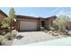 Single-story home with two-car garage and desert landscaping at 485 Pebble Run Ave, Henderson, NV 89011