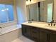 Double vanity bathroom with a large mirror and walk-in shower at 6483 Dove Point Pl, Las Vegas, NV 89130