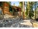 Rustic log cabin with stone pathway and wooded surroundings at 4075 Cougar Ridge Trl, Mount Charleston, NV 89124