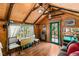 Rustic living room with wood-beamed ceiling and wood flooring at 4075 Cougar Ridge Trl, Mount Charleston, NV 89124