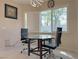 Bright breakfast nook with glass table and seating for three at 2451 Tour Edition Dr, Henderson, NV 89074