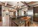 Island kitchen features copper farm sink, granite countertops, and custom cabinetry at 14 Corral De Tierra Pl, Henderson, NV 89052