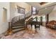 Elegant curved staircase with wrought iron railing and tiled flooring at 14 Corral De Tierra Pl, Henderson, NV 89052