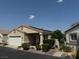 Tan stucco house with solar panels and a two-car garage at 4960 Mascaro Dr, Las Vegas, NV 89122