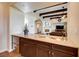 Wet bar with granite countertops and a view of the living room at 59 Portezza Dr, Henderson, NV 89011