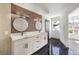 Elegant bathroom with double vanity and black tile floor at 8509 Copper Falls Ave, Las Vegas, NV 89129