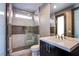 Modern bathroom with a glass shower and dark brown vanity at 11166 Villa Bellagio Dr, Las Vegas, NV 89141