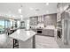 Modern kitchen with gray cabinets, large island, and stainless steel appliances at 26 Sun Mirage Ave, Henderson, NV 89011