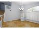 Bright dining room with hardwood floors, large window, and staircase at 2547 Quail Canyon Ave, Henderson, NV 89074