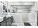 Spa-like bathroom featuring double sinks, a large walk-in shower, and modern fixtures at 4702 Steeplechase Ave, North Las Vegas, NV 89031