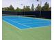 Well-maintained tennis court with blue surface and green perimeter at 92 Laying Up Ct, Las Vegas, NV 89148