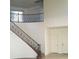 Elegant staircase with a wrought iron railing and wooden steps at 3608 Tundra Swan St, Las Vegas, NV 89122