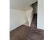 Indoor staircase with carpeted steps and neutral walls at 9033 Savvy Seam Ct, Las Vegas, NV 89149