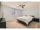 Bright bedroom with carpeted floor and large window at 10302 Artful Stone Ave, Las Vegas, NV 89149