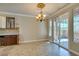 Elegant dining room with tile floor, chandelier, and access to patio at 9144 Ebony Threads Ct, Las Vegas, NV 89149