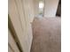 Simple carpeted bedroom with door to bathroom at 6444 Deadwood Rd, Las Vegas, NV 89108