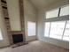 Living room with a fireplace and large windows at 6444 Deadwood Rd, Las Vegas, NV 89108