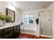 Bathroom with soaking tub, shower, and single vanity at 11334 Colinward Ave, Las Vegas, NV 89135