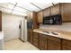 View of kitchen appliances and wood cabinets at 725 N Royal Crest Cir # 236, Las Vegas, NV 89169