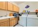 Laundry room with washer, dryer, cabinets, and utility sink at 7566 Catalina Harbor St, Las Vegas, NV 89131