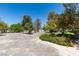 Gravel driveway with mature trees and landscaping at 1860 E Ford Ave, Las Vegas, NV 89123