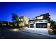 Stunning contemporary home with a two-car garage at night at 4181 Bronze Ridge St, Las Vegas, NV 89135