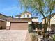 Two-story home with a two-car garage and landscaping at 5841 Petrified Tree Ln, North Las Vegas, NV 89081