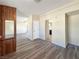 Living room with wood-paneled accent wall and wood flooring at 4850 Pontiac Cir, Pahrump, NV 89048