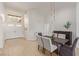 Bright dining room with dark wood table and light gray chairs near the entryway at 2633 Showcase Dr, Las Vegas, NV 89134