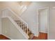 Bright and airy carpeted staircase with white railings at 5897 Passing Breeze Ct, Las Vegas, NV 89118