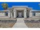 One-story house with gray exterior and stone accents at 1420 Logandale Dr, Logandale, NV 89021