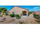 Landscaped backyard with gravel, plants, and a covered patio at 7952 Song Thrush St, North Las Vegas, NV 89084