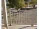 Concrete walkway with lake and trees, metal fence at 198 Adomeit Dr, Henderson, NV 89074